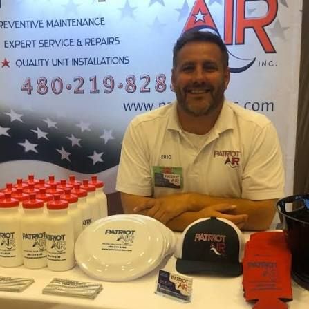 Eric Lipp, owner of Patriot Air, at a community booth with Patriot Air merchandise