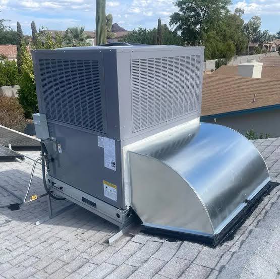 Completed rooftop package unit installation with desert landscape behind